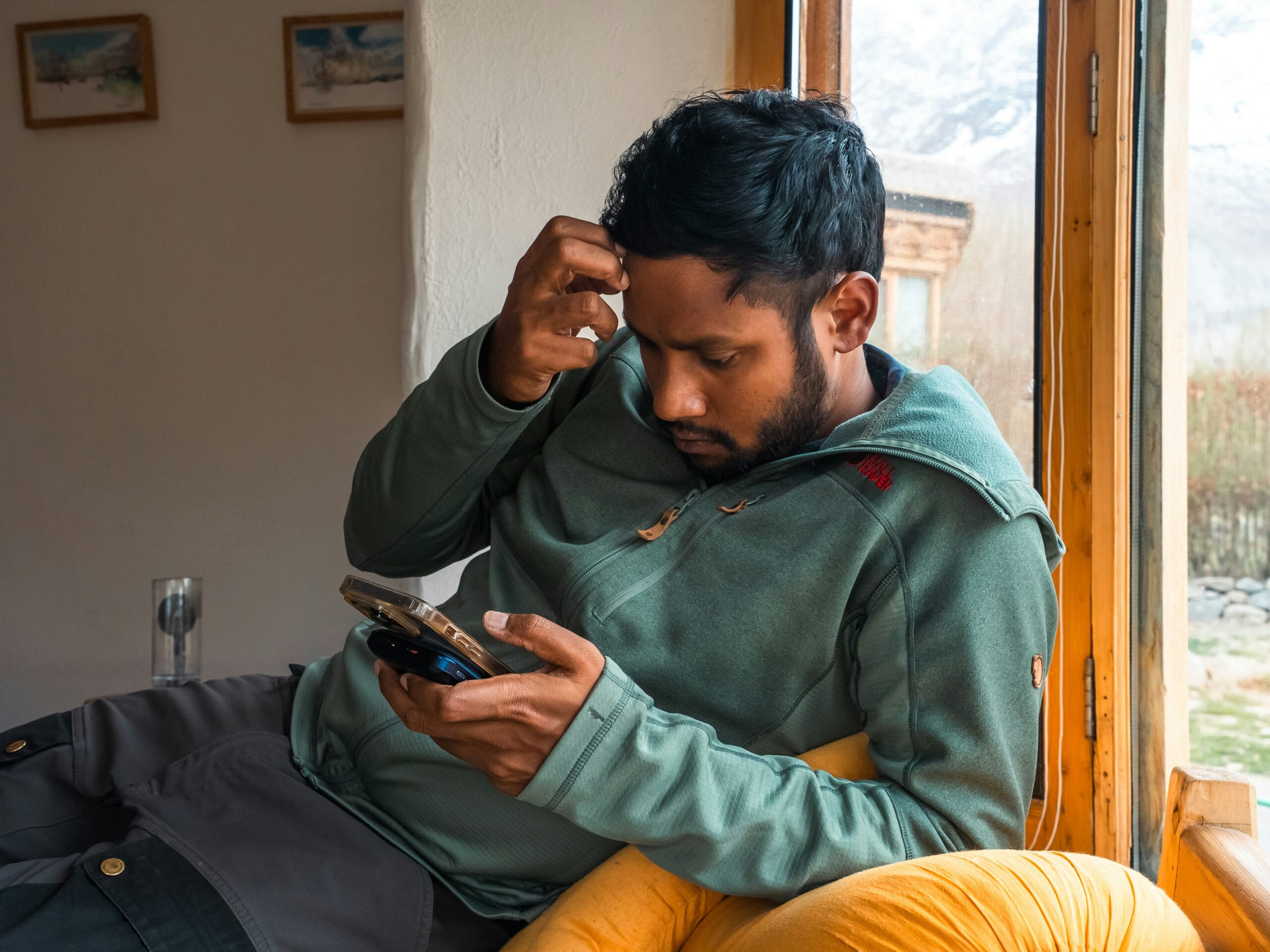 Person wartet mit Smartphone in der Hand auf eine Nachricht